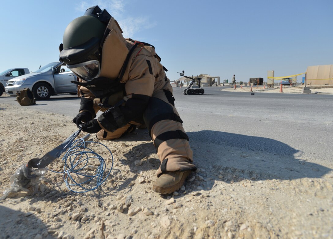 Navy Lt. j.g. Michael Aragon, assigned to Explosive Ordnance Disposal Mobile Unit 11, removes blasting caps from a detonation cord while dressed in a bomb suit during a training exercise in Bahrain in November 2012. DLA Troop Support provides equipment to Navy EOD customers through its Special Operations tailored logistics support program