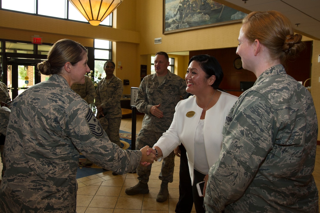 Chief Master Sgt. Beth Topa, 11th Wing command chief master sergeant, shakes the hand of Shereen Mesa, 11th Force Support Squadron Presidential Inn lodging manager, at the Presidential Inn at JBA, Md., Aug. 1, 2016. Topa visited several of the 11th Mission Support Group squadrons with Col. John Teichert, 11th WG and JBA commander, to become more familiar with the squadrons’ missions and meet with “America’s Airmen.” (U.S. Air Force photo by Airman 1st Class Rustie Kramer)