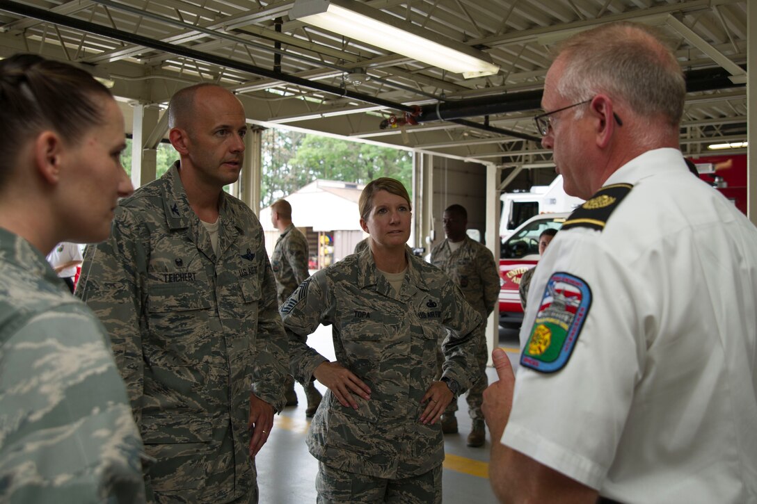 Col. John Teichert, 11th Wing and Joint Base Andrews commander, and Chief Master Sgt. Beth Topa, 11th WG command chief master sergeant, talk with Timothy Pitman, 11th Civil Engineer Squadron fire chief, at Fire Station One at JBA, Md., Aug. 1, 2016. Teichert visited several of the 11th Mission Support Group squadrons with Chief Master Sgt. Beth Topa, 11th WG command chief master sergeant, to become more familiar with the squadrons’ missions and meet with “America’s Airmen.” (U.S. Air Force photo by Airman 1st Class Rustie Kramer)