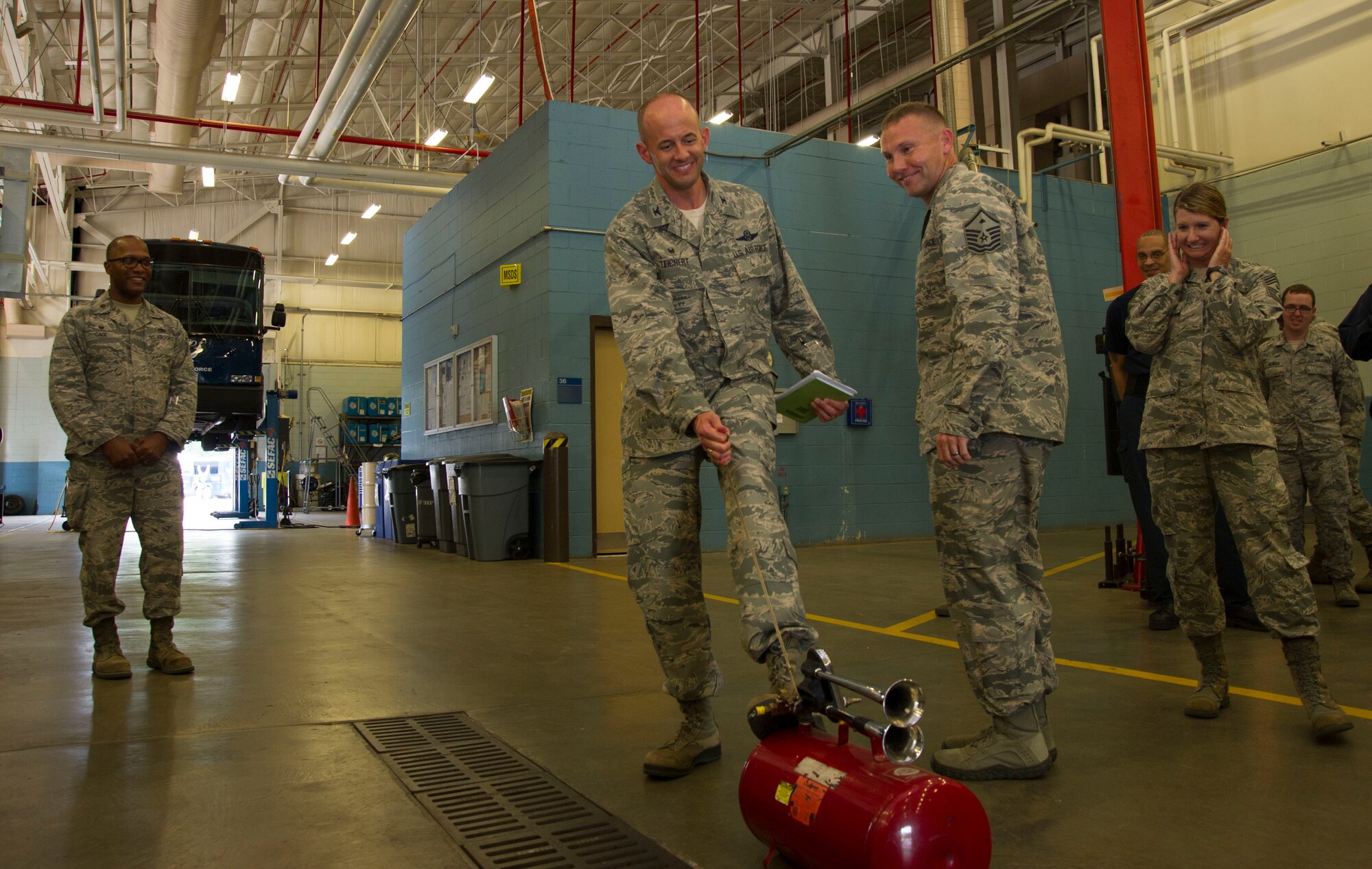 Col. John Teichert, 11th Wing and Joint Base Andrews commander, sounds an air horn at 11th Logistics Readiness Sqaudron vehicle maintenance bay on JBA, Md., Aug. 16, 2016. Teichert visited several of the 11th Mission Support Group squadrons with Chief Master Sgt. Beth Topa, 11th WG command chief master sergeant, to become more familiar with the squadrons’ missions and meet with “America’s Airmen.” (U.S. Air Force photo by Airman 1st Class Rustie Kramer)