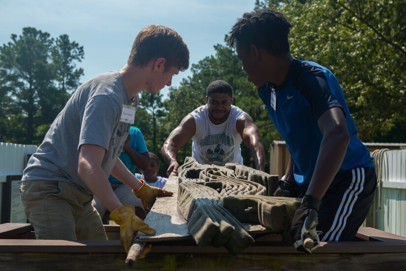 John Cumbie and Cam’ryn Rascoe, Youth Leadership Alliance of the Virginia Peninsula Chamber Foundation students, and Jonathan Sims, program assistant, work to complete a challenge on the leadership response course at Fort Eustis, Va., August 1, 2016.  The students visited Fort Eustis to learn team building skills from the leadership response course and hear leadership experiences from U.S. Army senior leaders. (U.S. Air Force photo by Staff Sgt. J.D. Strong II)