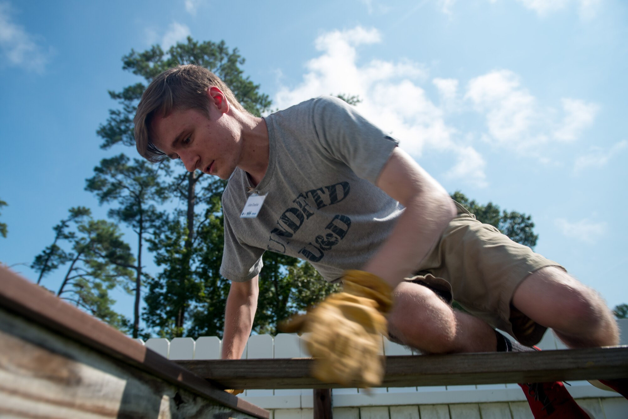 John Cumbie, Youth Leadership Alliance of the Virginia Peninsula Chamber Foundation student, crawls across an obstacle on the leadership response course at Fort Eustis, Va., August 1, 2016. The students solved six team building challenges while on the leadership response course, building stronger communications skills and increased confidence in their leadership and followership skills. (U.S. Air Force photo by Staff Sgt. J.D. Strong II)