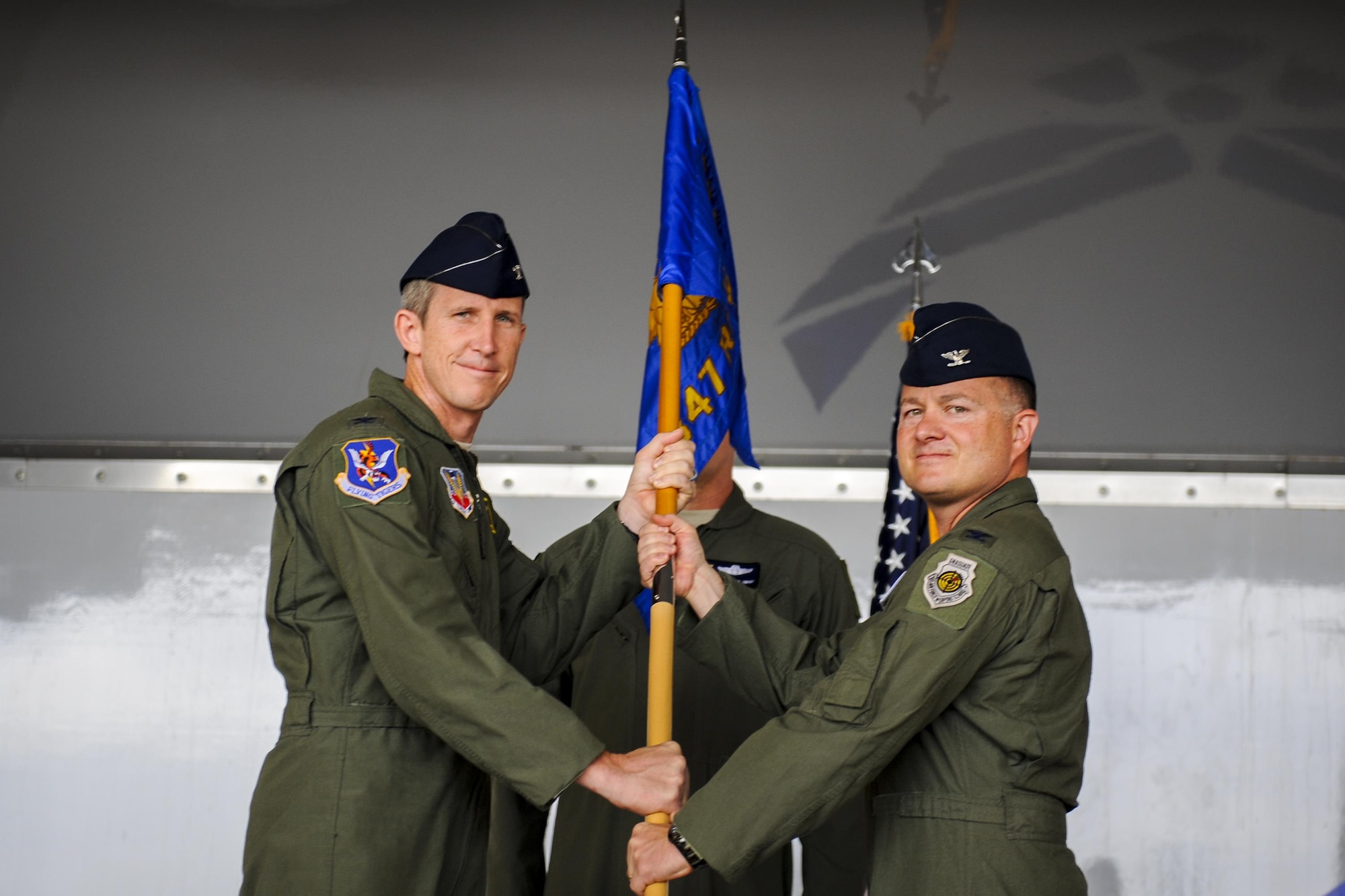 U.S. Air Force Col. Thomas Kunkel, 23d Wing commander, passes a guidon to Col. Jason Gingrich, 347th Rescue Group incoming commander, signifying his assumption of command, Aug. 2, 2016, at Moody Air Force Base, Ga. Gingrich deployed and flew in support of operations Enduring Freedom and Iraqi Freedom along with operations in the U.S. Africa Command. (U.S. Air Force photo by Airman Daniel Snider)
