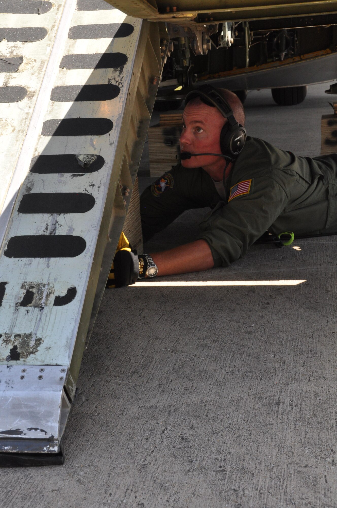 Staff Sgt. Cody Holsey, an Air Force Reserve C-5 loadmaster assigned to the 68th Airlift Squadron, positions a pedestal shore under the aircraft before loading a 45-passenger bus here Aug. 2. Members of the 301st Logistics
Readiness Squadron designed and created pedestal and approach shoring to safely load this bus without damaging the aircraft or vehicle. (U.S. Air Force photo by Capt. Candice Allen) 
