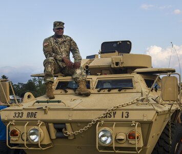 Lt. Anthony Hill, a Soldier assigned to the 200th Military Police Command, helps kids get in and out of an M1117 Armored Security Vehicle during the 33rd annual National Night Out at the McGlachlin Parade Field on Fort Meade, Md., Aug. 2. National Night Out is an annual community-building campaign that promotes partnerships with first-responder agencies to make neighborhoods safer and better places to live. The event was established in 1984 and participation has increased from 2.5 million people in 400 communities to more than 32 million people in 9,530 communities since. (U.S. Army Reserve photo by Spc. Stephanie Ramirez)