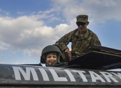 A child explores a Humvee during the 33rd annual National Night Out at the McGlachlin Parade Field on Fort Meade, Md., Aug. 2. National Night Out is an annual community-building campaign that promotes partnerships with first-responder agencies to make neighborhoods safer and better places to live. The event was established in 1984 and participation has increased from 2.5 million people in 400 communities to more than 32 million people in 9,530 communities since. Soldiers from the 200th Military Police Command had a static display with military vehicles, weapons and protective equipment. (U.S. Army Reserve photo by Spc. Stephanie Ramirez)