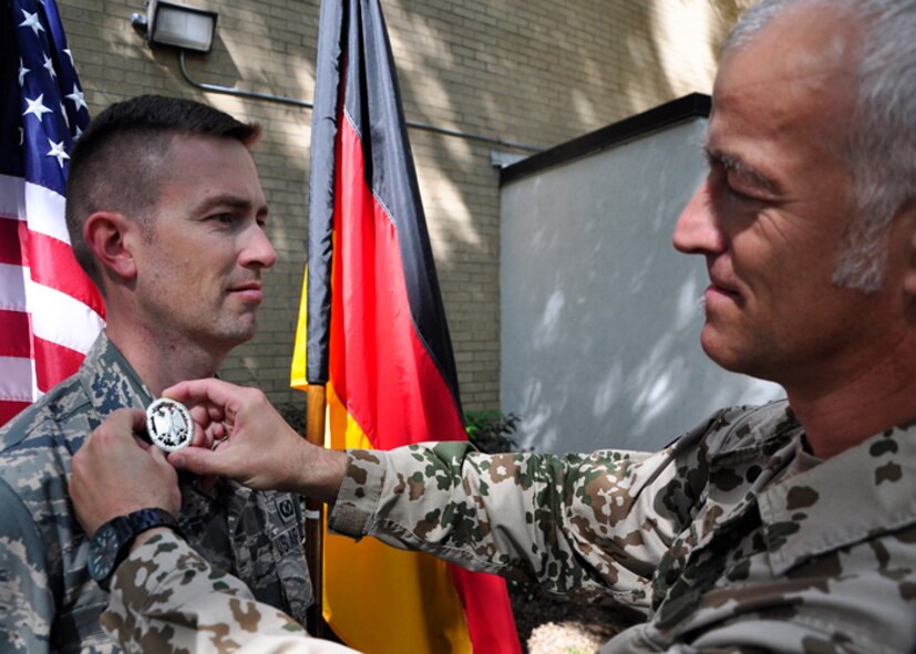 Maj. George Chapman, a former Air Command and Staff College student, receives a German Armed Forces Proficiency Badge from German liaison officer Sgt. Maj. Michael Kern at Maxwell's Air War College, May 4, 2016. (Courtesy photo)