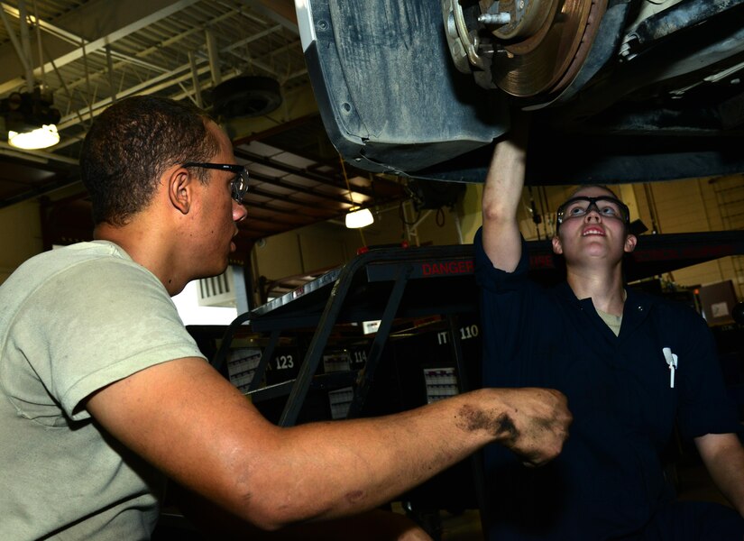 U.S. Air Force Airman 1st Class Taylor Elcook, 633rd Logistics Readiness Squadron vehicle maintenance apprentice, and U.S. Air Force Staff Sgt. Nina Rack, 633rd LRS vehicle maintenance supervisor, replace the engine wiring harness in a security forces vehicle at Langley Air Force Base, Va., Aug. 2, 2016. Vehicle maintenance does many things to keep the base running smoothly by performing small routine vehicle checks to major fixes like replacing the engine wiring harness. (U.S. Air Force photo by Airman 1st Class Tristan Biese)