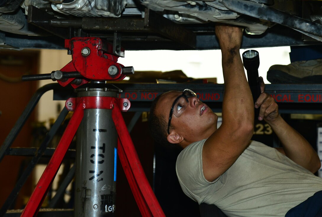 U.S. Air Force Airman 1st Class Taylor Elcook, 633rd Logistics Readiness Squadron vehicle maintenance apprentice, replaces the engine wiring harness in a police vehicle at Langley Air Force Base, Va., Aug. 2, 2016.  The vehicle maintenance shop assists the base by keeping all the government vehicles operating properly for the overall mission. (U.S. Air Force photo by Airman 1st Class Tristan Biese)