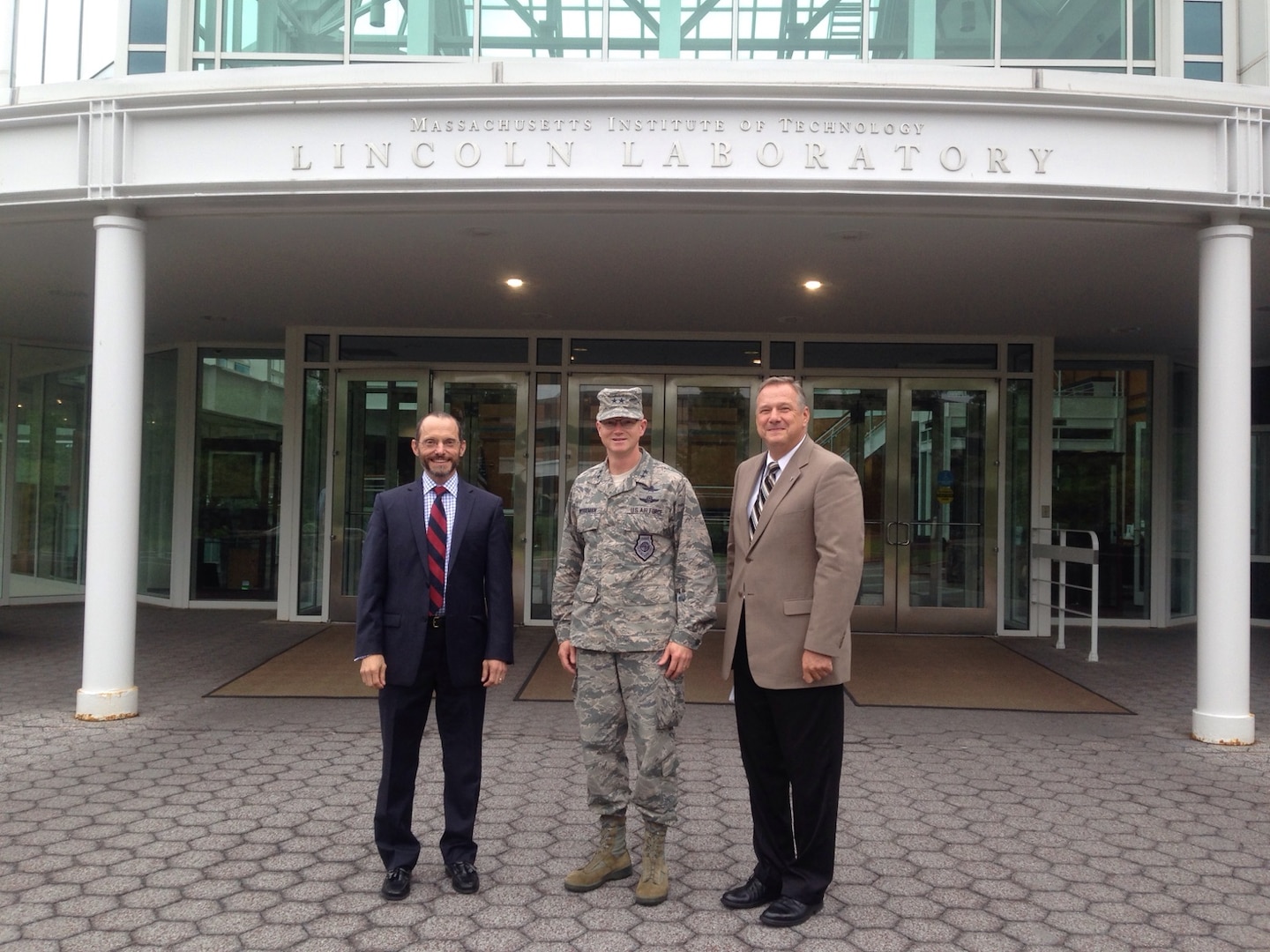 Maj. Gen. Christopher Weggeman, 24th Air Force commander, poses with Mr. Chris Putko (right), Executive Officer, Cyber Security and Communication Systems and Dr. Marc Zissman, Associate Division Head, Cyber Security and Communication Systems at Massachusetts Institute of Technology’s (MIT) Lincoln Laboratory, Lexington, Mass. 1 August.  The MIT cyber specialists briefed Weggeman on current research and development efforts related to cyber security, operations, and analytics.