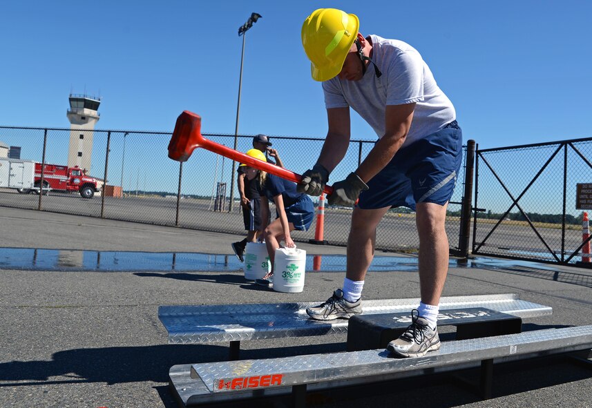 Tech. Sgt. Chris Stephens, 627th Logistics Readiness Squadron customer service NCOIC, uses a sledge hammer on a Keiser Force Machine July 26, 2016, during a firefighter combat challenge at Joint Base Lewis-McChord, Wash. The Keiser Force Machine is used by firefighters to simulate a forced entry using a sledge hammer. (U.S. Air Force photo/Senior Airman Jacob Jimenez) 