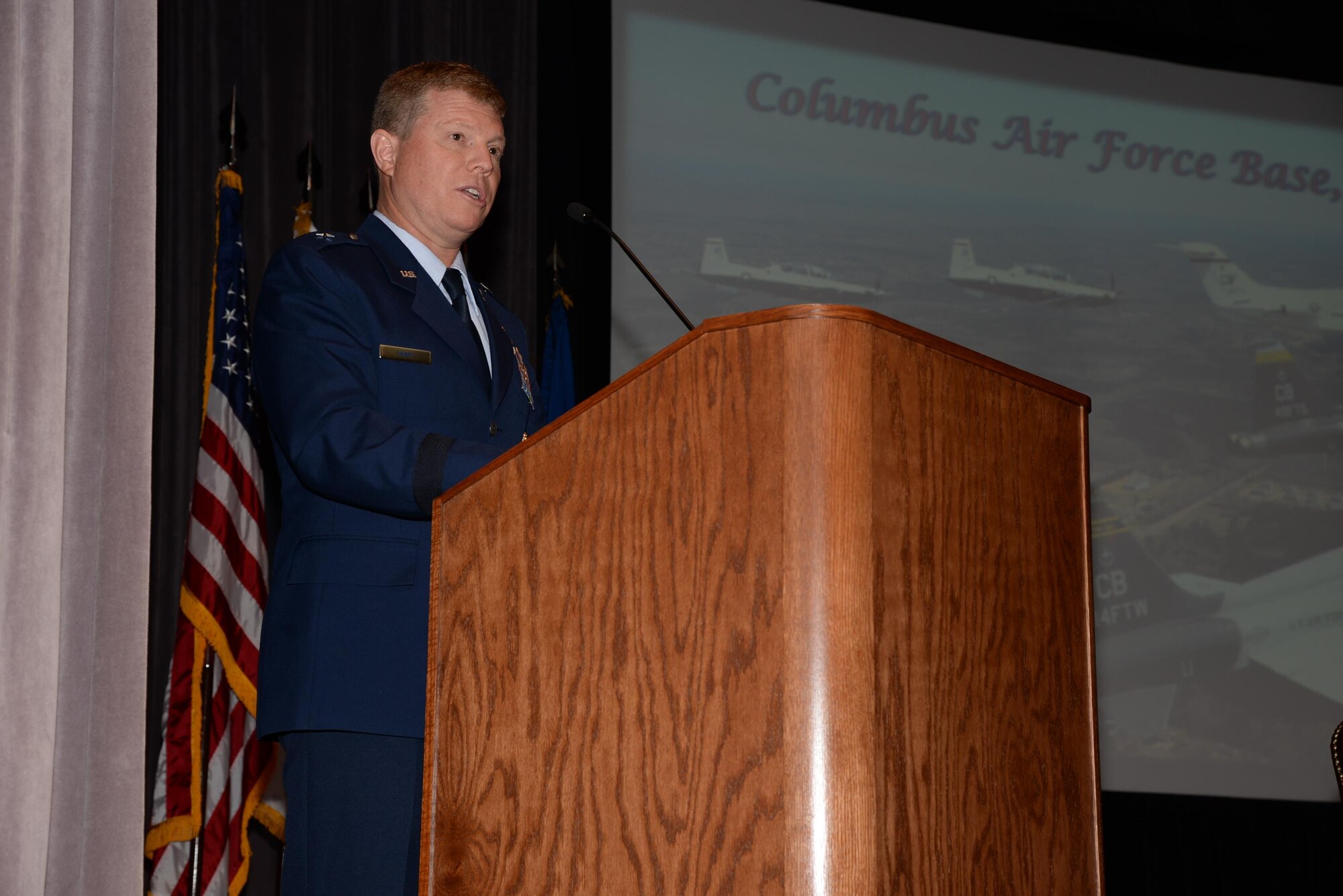 Brig. Gen. Andrew Croft, Director of Plans, Programs, Requirements and Assessments, Headquarters Air Education and Training Command, Joint Base San Antonio-Randolph, Texas speaks during the Specialized Undergraduate Pilot Training Class 16-12 graduation July 29 at Columbus Air Force Base, Mississippi. During his speech Croft set the bar for the high expectations that would be demanded of the young pilots in their future careers. (U.S. Air Force photo/Airman 1st Class John Day)