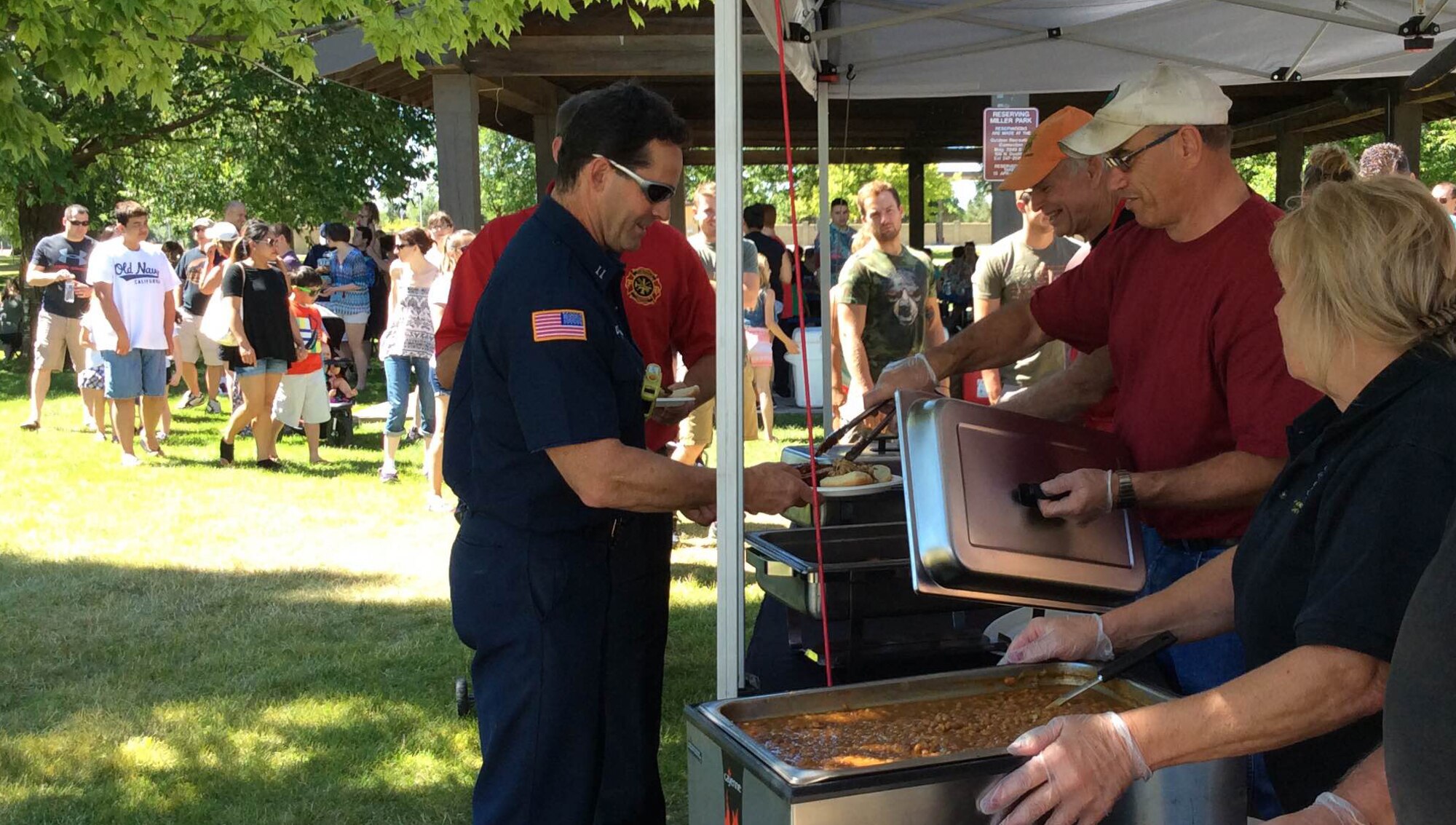 Airmen and their families line up to get BBQ smoked brisket, ribs, pulled pork, baked beans and slaw at the Military Appreciation BBQ on July 30, 2016, at Miller Park, Fairchild Air Force Base, Wash. The event was sponsored by Uncle Leroy & the Pit Masters, a local retailer at Spokane Public Market that provided the food to people at the base for free in appreciation of their service and sacrifice.
(U.S. Air Force photo/Airman 1st Class Ryan Lackey)
