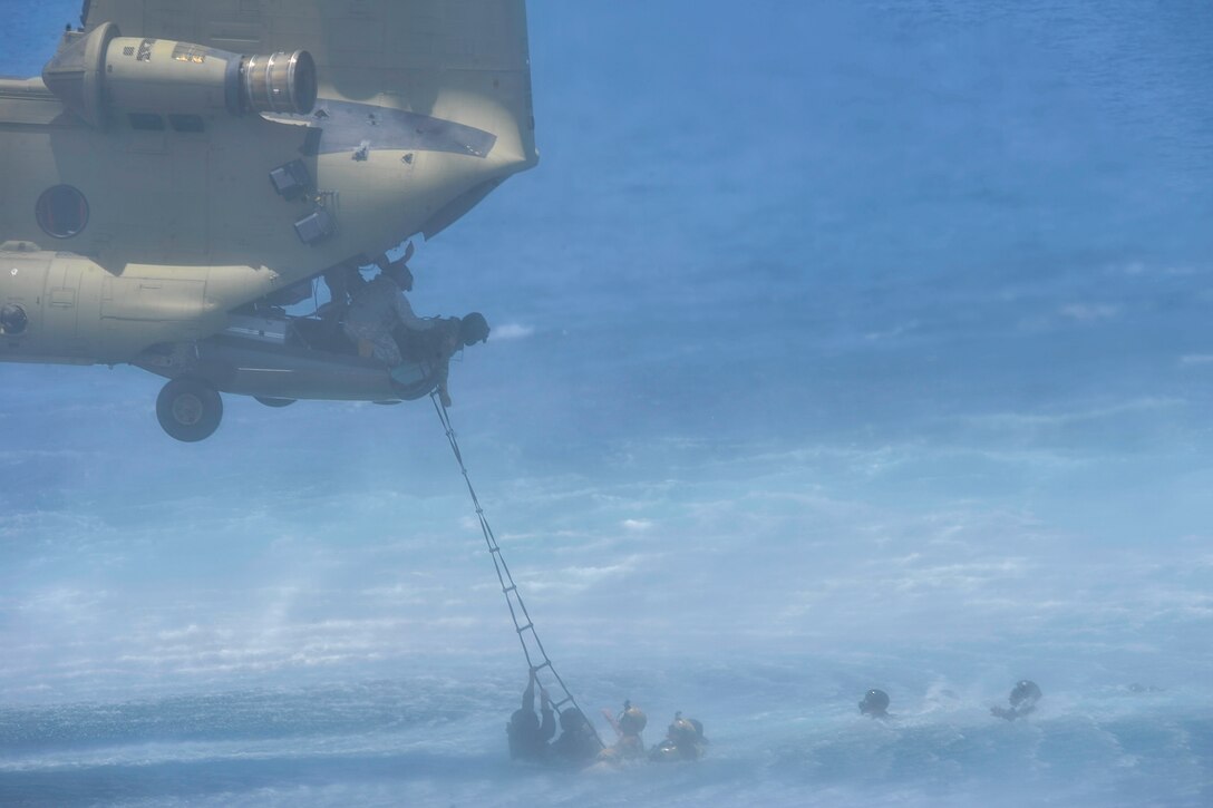 Members of the Belize Coast Guard prepare to climb a Jacobs Ladder to board a CH-47 Chinook assigned to Joint Task Force-Bravo’s 1st Battalion, 228th Aviation Regiment during training off the coast of Belize City, July 18, 2016. The 1-228th AVN conducted Fast Rope Insertion and Extraction System (FRIES) training, helocast operations and recovery, and open water hoist training with members of the Belize Special Assignment Group and BCG. (U.S. Air Force photo by Staff Sgt. Siuta B. Ika)