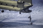 A member of the Belize Coast Guard climbs a Jacobs Ladder to board a CH-47 Chinook assigned to the 1st Battalion, 228th Aviation Regiment during training off the coast of Belize City, July 18, 2016. For many of the BCG participants, this was the first time they were part of helocast and recovery operations. (U.S. Air Force photo by Staff Sgt. Siuta B. Ika)