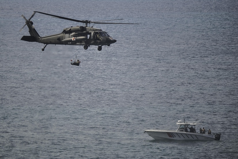 A UH-60L Black Hawk assigned to Joint Task Force-Bravo’s 1st Battalion, 228th Aviation Regiment carries a role player acting as a patient during medical evacuation training off the coast of Belize City, July 18, 2016. The 1-228th AVN’s U.S. Air Ambulance Detachment Honduras handles all of the battalion’s aeromedical operations, which include both training partner nations and providing real-world MEDEVAC capabilities throughout Central America. (U.S. Air Force photo by Staff Sgt. Siuta B. Ika) 