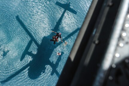 U.S. Army Staff Sgt. Jun Ma, a flight paramedic assigned to Joint Task Force-Bravo’s 1st Battalion, 228th Aviation Regiment, utilizes a hoist from a UH-60L Black Hawk to extract a role player acting as a patient during an open water hoist training scenario off the coast of Belize City, July 18, 2016. The 1-228th AVN conducted Fast Rope Insertion and Extraction System (FRIES) training, helocast operations and recovery, and open water hoist training with members of the Belize Special Assignment Group and Belize Coast Guard. (U.S. Air Force photo by Staff Sgt. Siuta B. Ika)