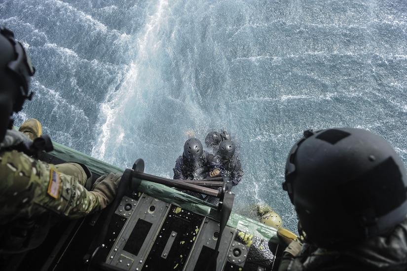 Members of the Belize Coast Guard climb a Jacobs Ladder to board a CH-47 Chinook assigned to Joint Task Force-Bravo’s 1st Battalion, 228th Aviation Regiment during training off the coast of Belize City, July 18, 2016. For many of the BCG participants, this was the first time they were part of helocast and recovery operations. (U.S. Air Force photo by Staff Sgt. Siuta B. Ika)