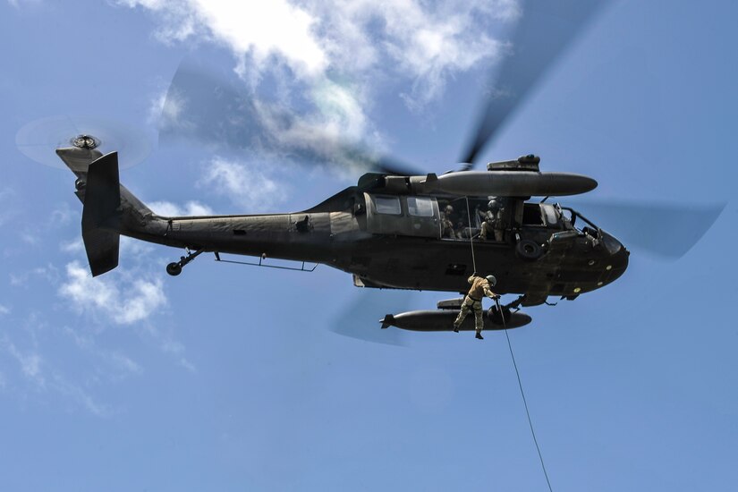 - A member of the Belize Special Assignment Group rappels out of a UH-60 Black Hawk assigned to Joint Task Force-Bravo’s 1st Battalion, 228th Aviation Regiment during training at Price Barracks, Belize, July 19, 2016. The 1-228th AVN conducted Fast Rope Insertion and Extraction System (FRIES) training, helocast operations and recovery with the Jacobs Ladder, and open water hoist training with members of the BSAG and Belize Coast Guard. (U.S. Air Force photo by Staff Sgt. Siuta B. Ika)