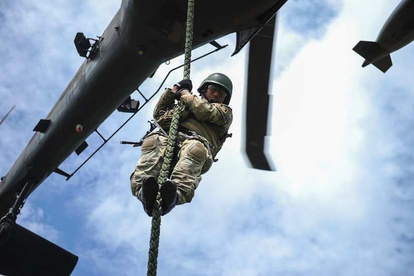 A member of the Belize Special Assignment Group fast ropes out of a UH-60 Black Hawk assigned to Joint Task Force-Bravo’s 1st Battalion, 228th Aviation Regiment during training at Price Barracks, Belize, July 19, 2016. For many of the BSAG participants, this was their first time they were part of Fast Rope Insertion and Extraction System (FRIES) training. (U.S. Air Force photo illustration by Staff Sgt. Siuta B. Ika)