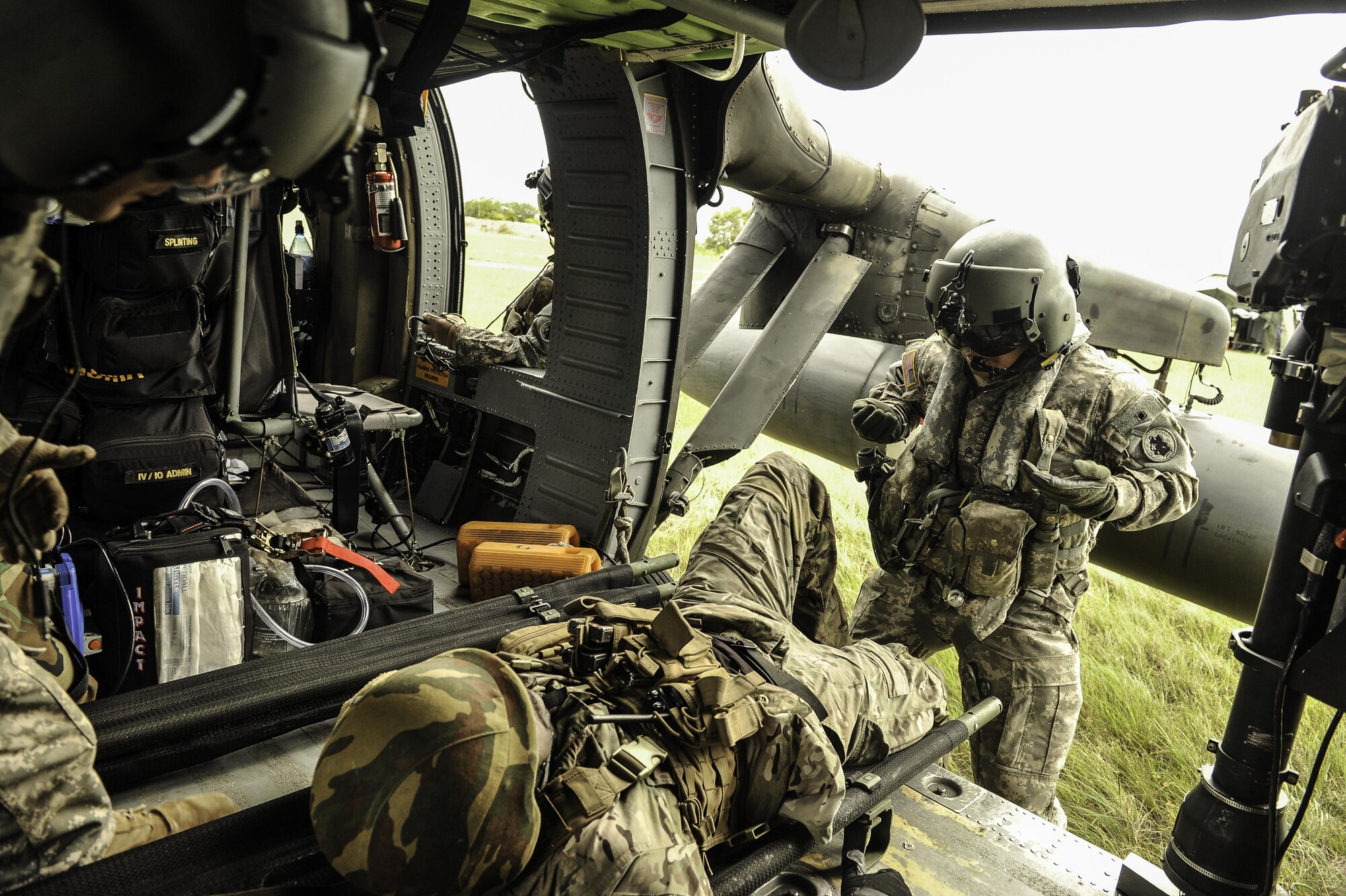 U.S. Army Staff Sgt. Jun Ma, a flight paramedic assigned to Joint Task Force-Bravo’s 1st Battalion, 228th Aviation Regiment, instructs a role player acting as a patient during a medical evacuation training scenario in Belize District, July 20, 2016. The Belize Special Assignment Group and Belize Coast Guard conducted various helicopter operations throughout the week of July 18-22 that increased their capacity to conduct counter-transnational organized crime operations. (U.S. Air Force photo by Staff Sgt. Siuta B. Ika)