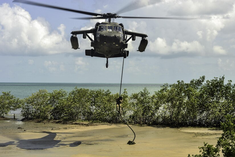 A member of the Belize Special Assignment Group fast ropes out of a UH-60 Black Hawk assigned to Joint Task Force-Bravo’s 1st Battalion, 228th Aviation Regiment during training in Belize District, July 21, 2016. The 1-228th AVN conducts aviation operations throughout the U.S. Southern Command area of responsibility. (U.S. Air Force photo by Staff Sgt. Siuta B. Ika)