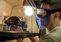 Senior Airman Christopher Buccieri, 375th Logistical Readiness Squadron fuels laboratory technician, tests a fuel sample to determine the presence of particulates. (U.S. Air Force photo by Staff Sgt. Martinez/Released)