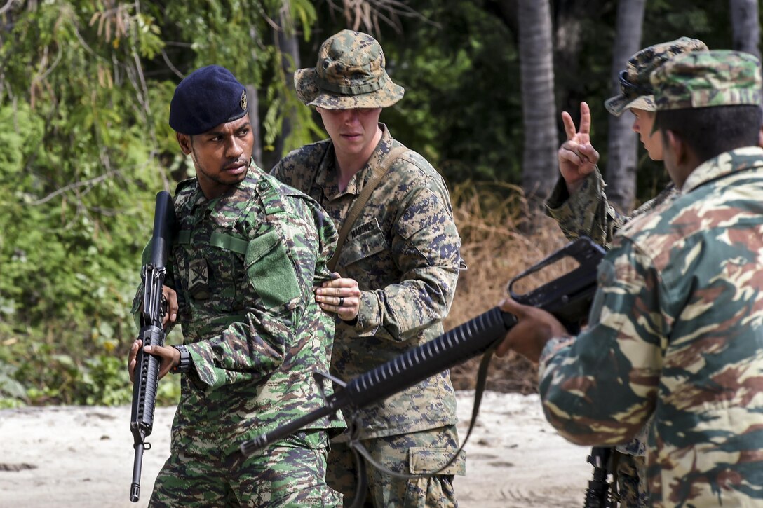 A Marine instructs a Timor Leste service member on how to conduct a room search during Cooperation Afloat Readiness and Training Timor Leste 2016, an exercise in Dili, Timor-Leste, Aug. 2, 2016. The Marines are assigned to Fleet Antiterrorism Security Team Pacific. Navy photo by Petty Officer 1st Class Rosalie Chang