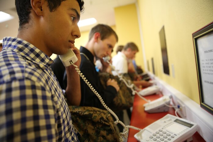 Recruits of India Company, 3rd Recruit Training Battalion, make their phone calls home, reading only what is printed on the script in front of them, during receiving at Marine Corps Recruit Depot San Diego, Aug. 1. Recruits will not be able to make another phone call until the end of recruit training. Annually, more than 17,000 males recruited from the Western Recruiting Region are trained at MCRD San Diego. India Company is scheduled to graduate Oct. 28.