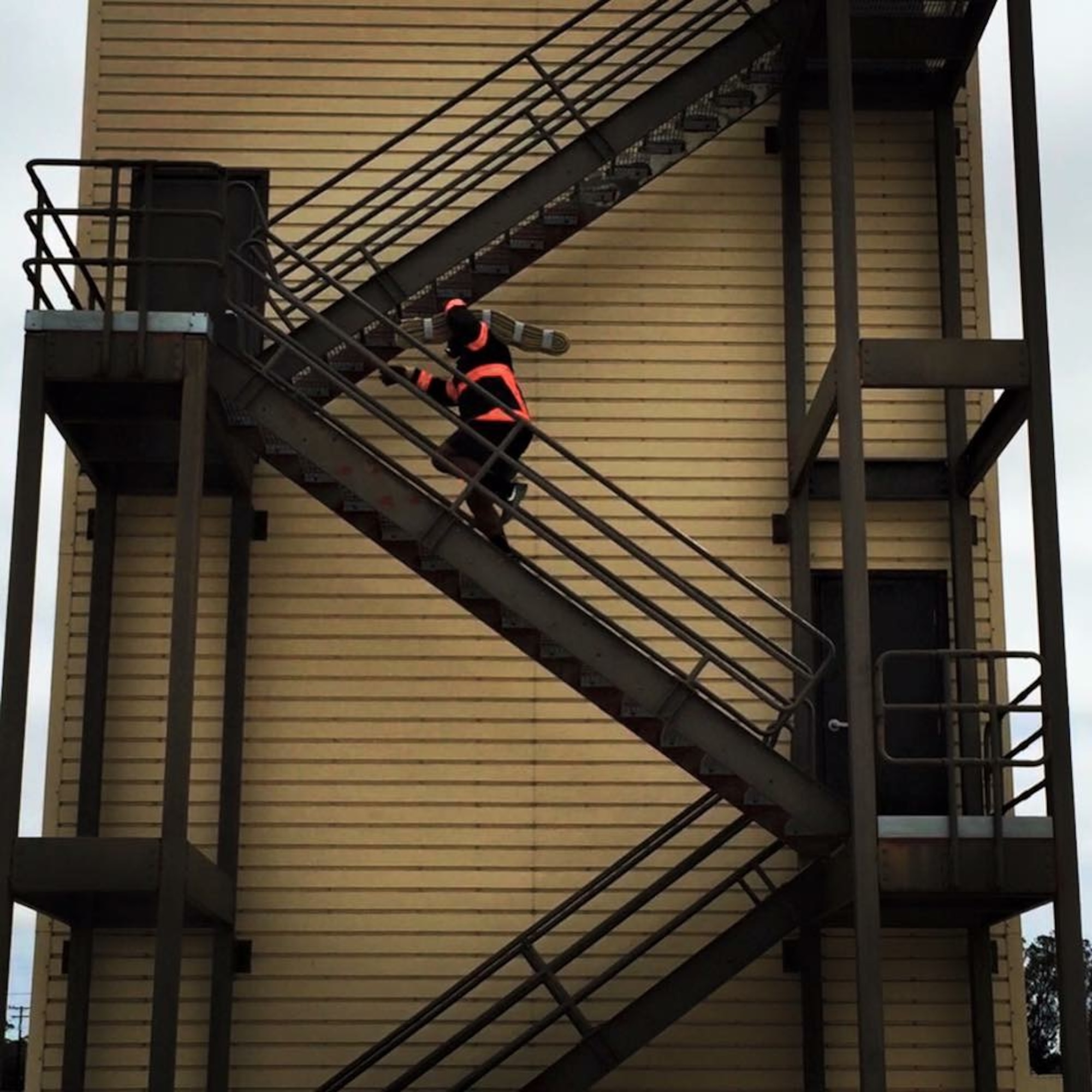 Lamont Brown, 30th Civil Engineer Squadron fire engineer, runs up the training tower with 45-pounds of hose-pack during practice, July 30, 2016, Vandenberg Air Force Base, Calif. A team of nine from Vandenberg Air Force base recently stepped up their training game, in preparation for this year’s Scott Firefighter Combat Challenge held in Reno, Nevada in October. (Courtesy photo)