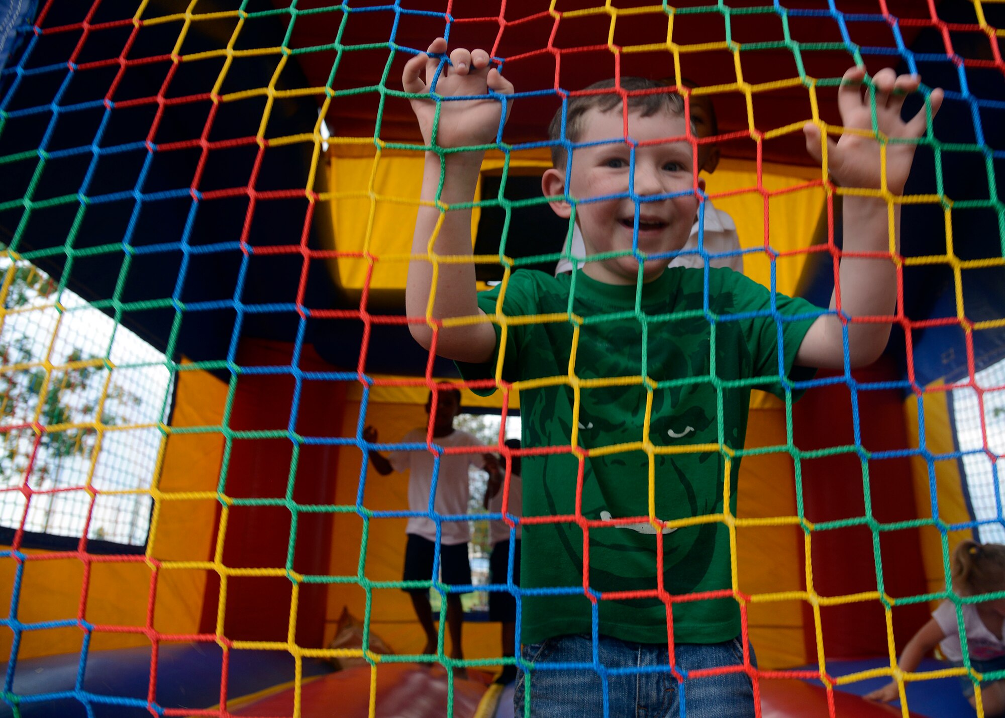 A Luke family member plays inside a jump house during the Back to School Bash Aug. 2, 2016 at Luke Air Force Base, Ariz. The event was sponsored by the Luke Chapel as a way to give back to the community as well as prepare children for the upcoming school year. More than 500 people came out for the event.(U.S. Air Force photo by Senior Airman Devante Williams)