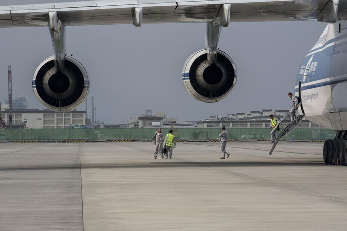 Russian crew members work to unload a KC-130J flight simulator from an AN-124 Ruslan aircraft on Marine Corps Air Station Iwakuni, Japan, Aug. 2, 2016. The aircraft delivered a KC-130J flight simulator that will later be installed in the base’s Operational Training Complex. Upon its completion, MCAS Iwakuni’s OTC will be the largest in the Marine Corps. (U.S. Marine Corps Photo by Cpl. Nathan Wicks)