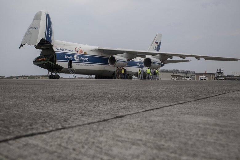 Russian crew members work to unload a KC-130J flight simulator from an AN-124 Ruslan aircraft on Marine Corps Air Station Iwakuni, Japan, Aug. 2, 2016. The aircraft delivered a KC-130J flight simulator that will later be installed in the base’s Operational Training Complex. Upon its completion, MCAS Iwakuni’s OTC will be the largest in the Marine Corps. (U.S. Marine Corps Photo by Cpl. Nathan Wicks)