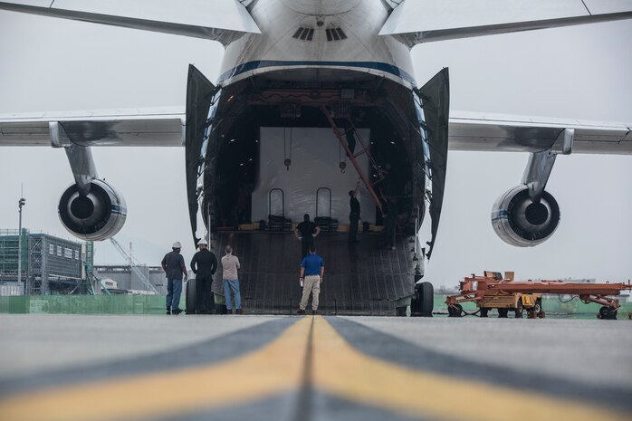 Russian crew members work to unload a KC-130J flight simulator from an AN-124 Ruslan aircraft on Marine Corps Air Station Iwakuni, Japan, Aug. 2, 2016. The aircraft delivered a KC-130J flight simulator that will later be installed in the base’s Operational Training Complex. Upon its completion, MCAS Iwakuni’s OTC will be the largest in the Marine Corps. (U.S. Marine Corps Photo by Cpl. Nathan Wicks)