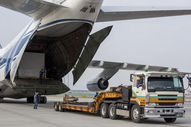 Russian crew members work to unload a KC-130J flight simulator from an AN-124 Ruslan aircraft on Marine Corps Air Station Iwakuni, Japan, Aug. 2, 2016. The aircraft delivered a KC-130J flight simulator that will later be installed in the base’s Operational Training Complex. Upon its completion, MCAS Iwakuni’s OTC will be the largest in the Marine Corps. (U.S. Marine Corps Photo by Cpl. Nathan Wicks)