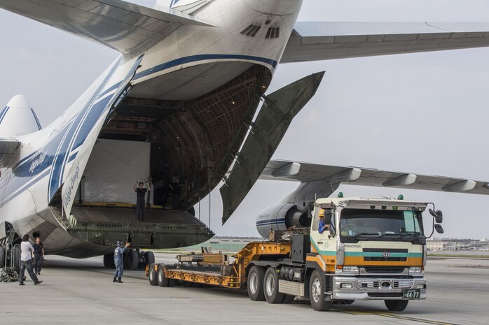 Russian crew members work to unload a KC-130J flight simulator from an AN-124 Ruslan aircraft on Marine Corps Air Station Iwakuni, Japan, Aug. 2, 2016. The aircraft delivered a KC-130J flight simulator that will later be installed in the base’s Operational Training Complex. Upon its completion, MCAS Iwakuni’s OTC will be the largest in the Marine Corps. (U.S. Marine Corps Photo by Cpl. Nathan Wicks)