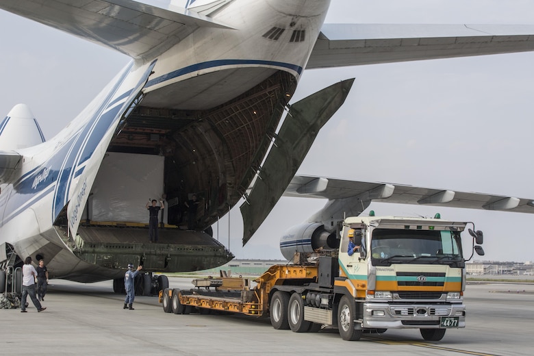 Russian crew members work to unload a KC-130J flight simulator from an AN-124 Ruslan aircraft on Marine Corps Air Station Iwakuni, Japan, Aug. 2, 2016. The aircraft delivered a KC-130J flight simulator that will later be installed in the base’s Operational Training Complex. Upon its completion, MCAS Iwakuni’s OTC will be the largest in the Marine Corps. (U.S. Marine Corps Photo by Cpl. Nathan Wicks)