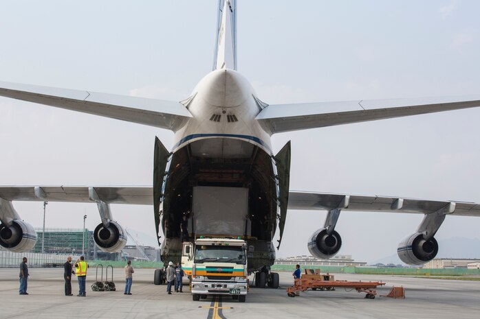 Russian crew members work to unload a KC-130J flight simulator from an AN-124 Ruslan aircraft on Marine Corps Air Station Iwakuni, Japan, Aug. 2, 2016. The aircraft delivered a KC-130J flight simulator that will later be installed in the base’s Operational Training Complex. Upon its completion, MCAS Iwakuni’s OTC will be the largest in the Marine Corps. (U.S. Marine Corps Photo by Cpl. Nathan Wicks)