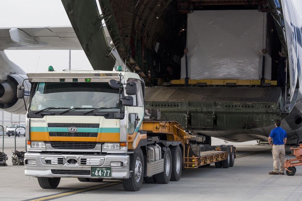 Russian crew members work to unload a KC-130J flight simulator from an AN-124 Ruslan aircraft on Marine Corps Air Station Iwakuni, Japan, Aug. 2, 2016. The aircraft delivered a KC-130J flight simulator that will later be installed in the base’s Operational Training Complex. Upon its completion, MCAS Iwakuni’s OTC will be the largest in the Marine Corps. (U.S. Marine Corps Photo by Cpl. Nathan Wicks)