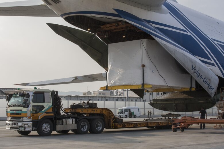 Russian crew members work to unload a KC-130J flight simulator from an AN-124 Ruslan aircraft on Marine Corps Air Station Iwakuni, Japan, Aug. 2, 2016. The aircraft delivered a KC-130J flight simulator that will later be installed in the base’s Operational Training Complex. Upon its completion, MCAS Iwakuni’s OTC will be the largest in the Marine Corps. (U.S. Marine Corps Photo by Cpl. Nathan Wicks)