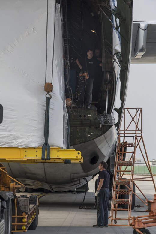 Russian crew members work to unload a KC-130J flight simulator from an AN-124 Ruslan aircraft on Marine Corps Air Station Iwakuni, Japan, Aug. 2, 2016. The aircraft delivered a KC-130J flight simulator that will later be installed in the base’s Operational Training Complex. Upon its completion, MCAS Iwakuni’s OTC will be the largest in the Marine Corps. (U.S. Marine Corps Photo by Cpl. Nathan Wicks)