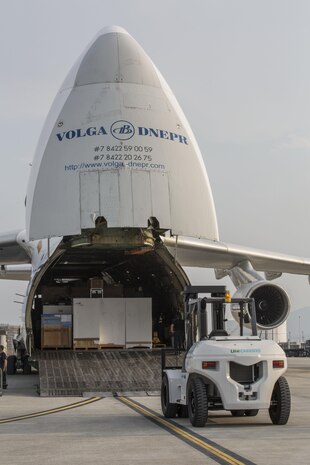 Russian crew members work to unload a KC-130J flight simulator from an AN-124 Ruslan aircraft on Marine Corps Air Station Iwakuni, Japan, Aug. 2, 2016. The aircraft delivered a KC-130J flight simulator that will later be installed in the base’s Operational Training Complex. Upon its completion, MCAS Iwakuni’s OTC will be the largest in the Marine Corps. (U.S. Marine Corps Photo by Cpl. Nathan Wicks)