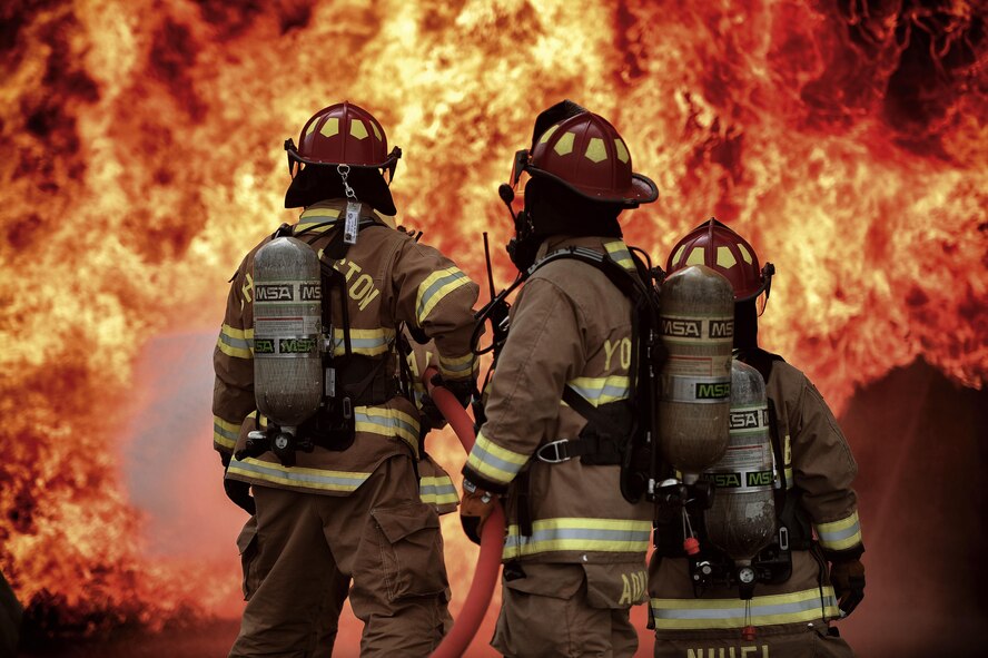 Firefighters with the 374th Civil Engineer Squadron battle a simulated aircraft fire during fire training at Yokota Air Base, Japan, Aug. 1, 2016. Aircraft live fire training is conducted every year, throughout the year to ensure Airmen are always prepared to combat aircraft fuel fires. (U.S. Air Force photo by Senior Airman Delano Scott/Released)