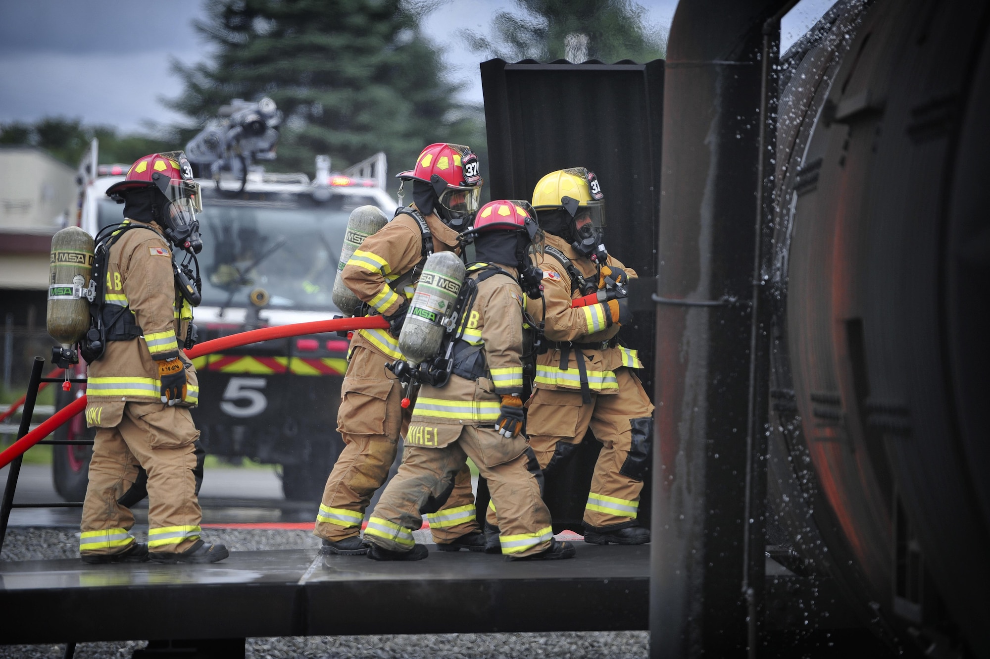 Firefighters with the 374th Civil Engineer Squadron battle a simulated aircraft fire during fire training at Yokota Air Base, Japan, Aug. 1, 2016. Aircraft live fire training is conducted every year, throughout the year to ensure Airmen are always prepared to combat aircraft fuel fires. (U.S. Air Force photo by Senior Airman Delano Scott/Released)