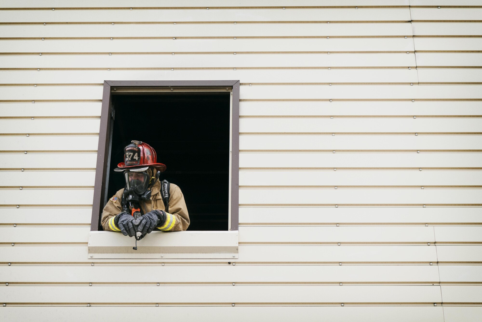 Staff Sgt. Kyle Wirth, 374th Civil Engineer Squadron firefighter, watches firefighters prepare to enter the fire training facility at Yokota Air Base, Japan, Aug. 1, 2016. Yokota uses a variety of facilities to train firefighters, including aircraft, building and flashover (or suddenly-flaring) fires. (U.S. Air Force photo by Senior Airman Delano Scott/Released)  