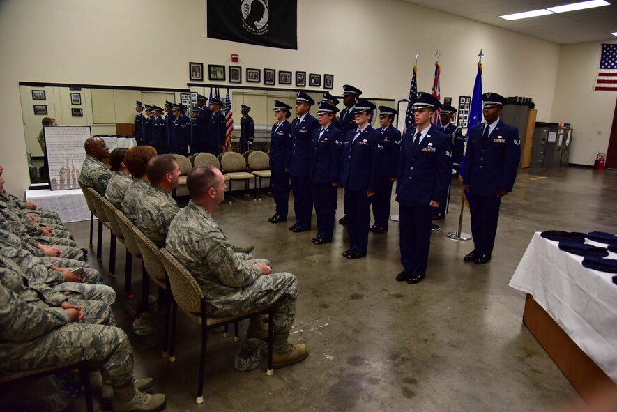 The newest members of Hickam's Honor Guard stand at attention during Hickam's Honor Guard graduation, held July 29 at the Honor Guard building, located here on JBPHH. The event was the culmination of 45-hours of training, which transformed Airmen from across Hickam into Honor Guardsmen. (U.S. Air Force photo by Staff Sgt. Christopher Stoltz)