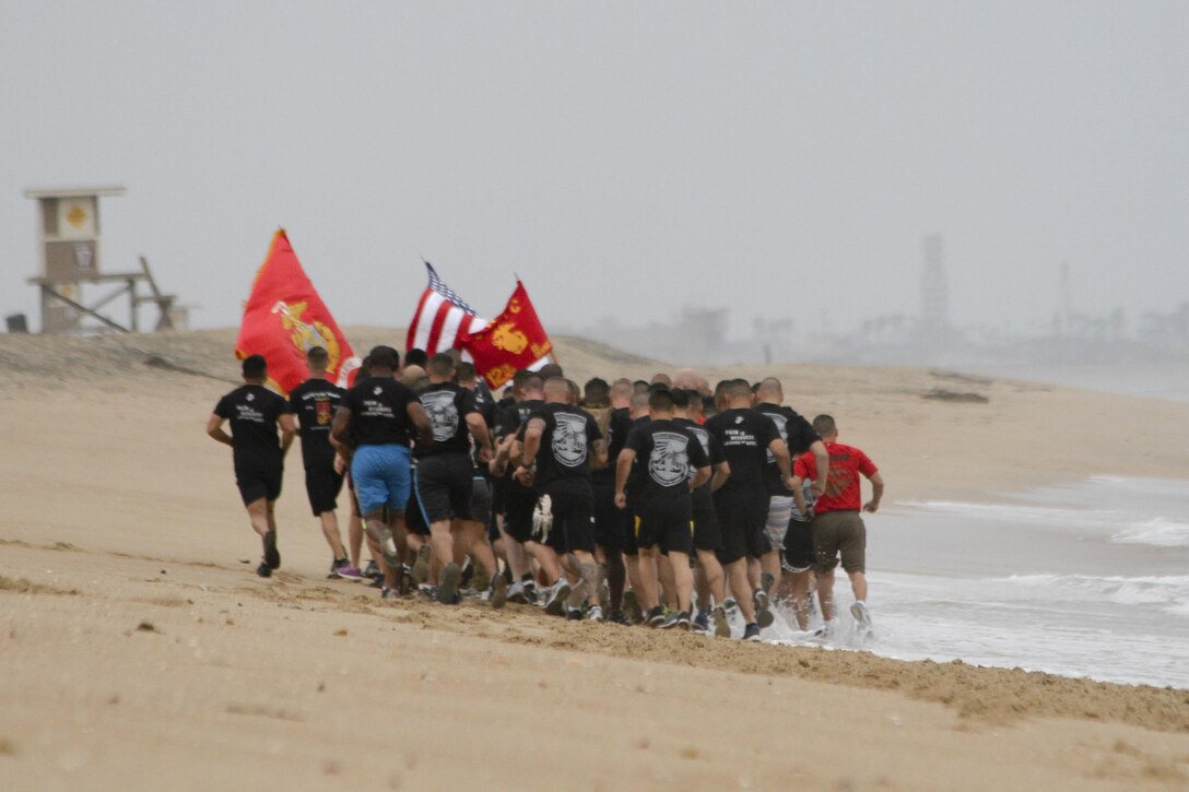 Marines with Marine Corps Recruiting Station Orange County stormed Huntington State Beach June 10, 2016 for a beach run. The purpose of the approximately four mile physical training session was to build morale, camaraderie and to conduct a reenlistment ceremony in the water for Gunnery Sgt. Kevin Aguilar and Sgt. Victor Galvan, both canvassing recruiters with RS Orange County. (U.S. Marine Corps photo by Sgt. Vanessa Jimenez)