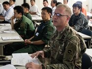Army Lt. Col. Bryan C. Jones, commander, U.S. Army Aviation Battalion-Japan, explains his command’s aviation assets and capabilities during the second Tachikawa Helicopter Conference conducted July 26, 2016, in Camp Tachikawa, Japan. Hosted by the JGSDF Eastern Army, the conference brought together representatives from the Japan Self-Defense Forces, United States military branches, and Japan’s civil aviation authorities to exchange information and develop policies to conduct helicopter operations during a major disaster. As the only rotary wing battalion stationed in Japan, USAABJ serves as U.S. Army Japan’s primary asset for aviation support. USAABJ’s close partnership with its Japanese aviation counterparts has produced a bilateral agreement for the battalion to assist in an emergency response operation or disaster relief mission if the Japanese government requests it.  (U.S. Army photo by Sgt. John L. Carkeet IV, U.S. Army Japan)