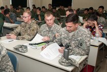 From left to right: Army Lt. Col. Bryan C. Jones, commander, U.S. Army Aviation Battalion-Japan, Army Maj. Nolan D. Roggenkamp (center), operations officer, USAABJ, and Army Staff Sgt. Joel Redman, crew chief, USAABJ, review the agenda for the second Tachikawa Helicopter Conference conducted July 26, 2016, in Camp Tachikawa, Japan. Hosted by the JGSDF Eastern Army, the conference brought together representatives from the Japan Self-Defense Forces, United States military branches, and Japan’s civil aviation authorities to exchange information and develop policies to conduct helicopter operations during a major disaster. As the only rotary wing battalion stationed in Japan, U.S. Army Aviation Battalion-Japan serves as U.S. Army Japan’s primary asset for aviation support. USAABJ’s close partnership with its Japanese aviation counterparts has produced a bilateral agreement for the battalion to assist in an emergency response operation or disaster relief mission if the Japanese government requests it. (U.S. Army photo by Sgt. John L. Carkeet IV, U.S. Army Japan)