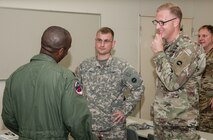 Army Lt. Col. Bryan C. Jones (right), commander, U.S. Army Aviation Battalion-Japan, and Army Maj. Nolan D. Roggenkamp (center), operations officer, USAABJ, discuss how to best coordinate aviation assets with their U.S. Air Force counterpart during the second Tachikawa Helicopter Conference conducted July 26, 2016, in Camp Tachikawa, Japan. Hosted by the JGSDF Eastern Army, the conference brought together representatives from the Japan Self-Defense Forces, United States military branches, and Japan’s civil aviation authorities to exchange information and develop policies to conduct helicopter operations during a major disaster. As the only rotary wing battalion stationed in Japan, USAABJ serves as U.S. Army Japan’s primary asset for aviation support. USAABJ’s close partnership with its Japanese aviation counterparts has produced a bilateral agreement for the battalion to assist in an emergency response operation or disaster relief mission if the Japanese government requests it. (U.S. Army photo by Sgt. John L. Carkeet IV, U.S. Army Japan)